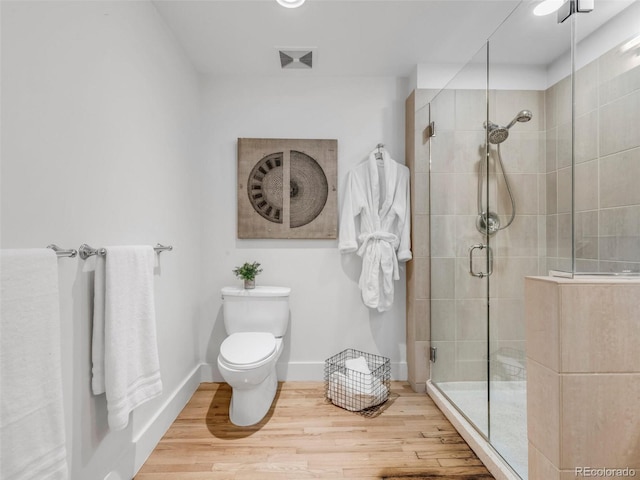 1449 Wynkoop St Unit 305, Denver, CO 80202 - full bathroom with wood finished floors, a stall shower, toilet, and baseboards