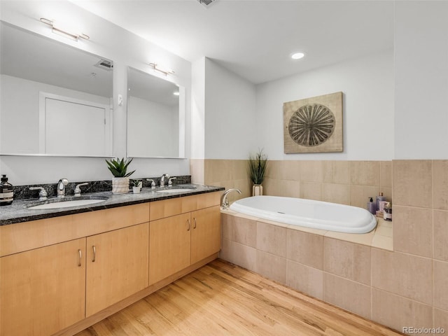 1449 Wynkoop St Unit 305, Denver, CO 80202 - bathroom with wood finished floors, a garden tub, and double vanity