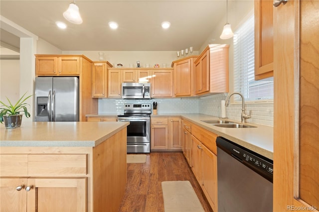 kitchen featuring appliances with stainless steel finishes, dark wood-type flooring, sink, light brown cabinets, and hanging light fixtures