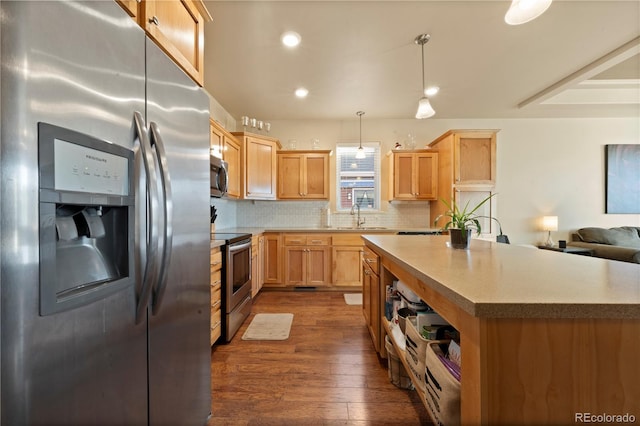 kitchen with decorative backsplash, stainless steel appliances, dark wood-type flooring, pendant lighting, and a center island