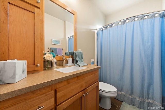 bathroom featuring tile patterned flooring, vanity, and toilet