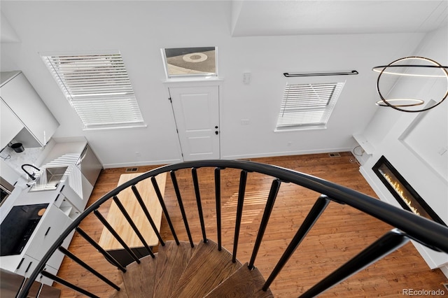 stairs featuring hardwood / wood-style flooring