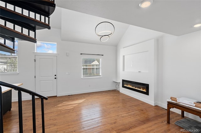 entrance foyer with lofted ceiling and wood-type flooring