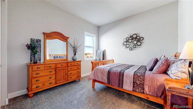 carpeted bedroom featuring baseboards