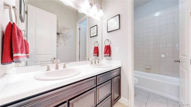 bathroom featuring double vanity, tile patterned flooring, a sink, and toilet