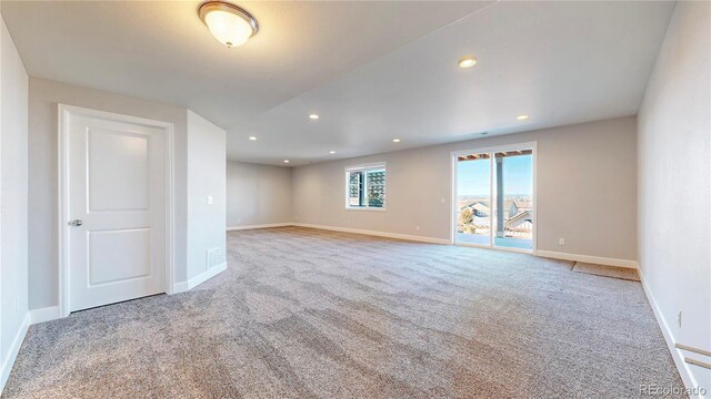 carpeted spare room with recessed lighting and baseboards