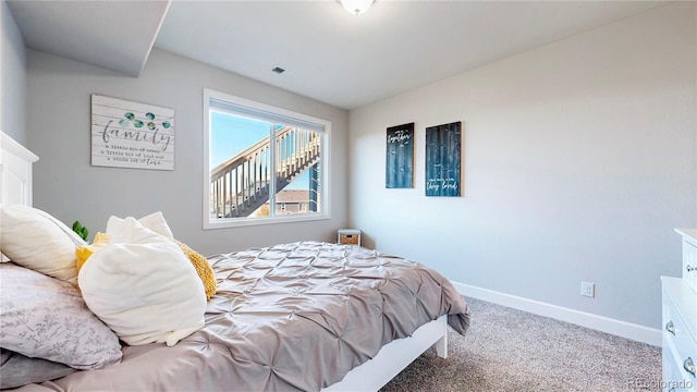 carpeted bedroom featuring visible vents and baseboards