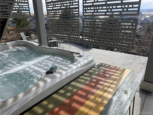 exterior space featuring an outdoor hot tub