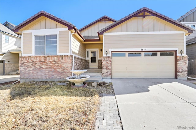 craftsman-style house with a garage, brick siding, driveway, and a tiled roof