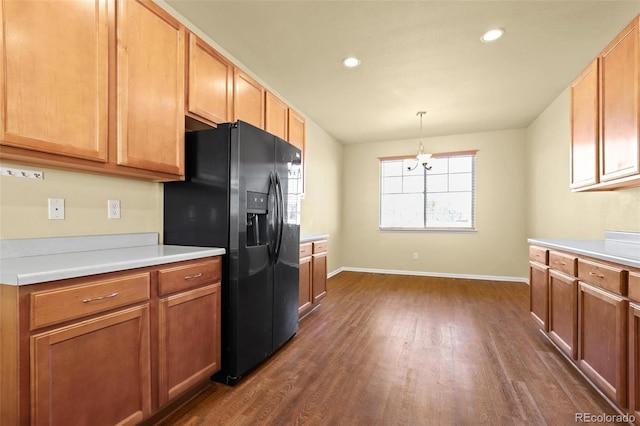 kitchen with recessed lighting, dark wood-type flooring, baseboards, light countertops, and black refrigerator with ice dispenser