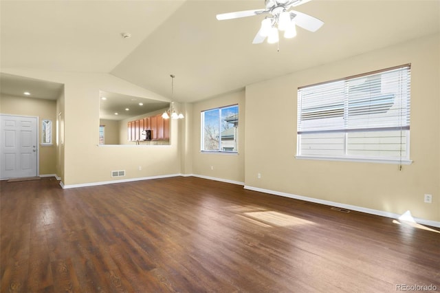 unfurnished living room with lofted ceiling, baseboards, visible vents, and dark wood finished floors