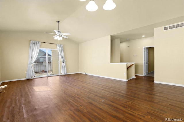 spare room with lofted ceiling, visible vents, ceiling fan, wood finished floors, and baseboards