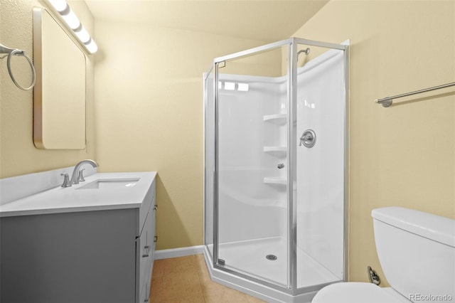 bathroom featuring toilet, a shower stall, tile patterned flooring, and vanity