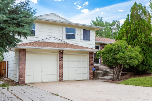 1775 S Memphis St, Aurora, CO 80017 - split level home featuring driveway, brick siding, a garage, and a shingled roof