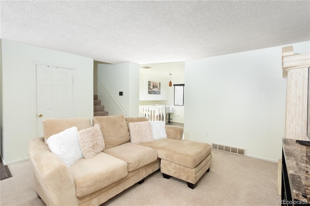 1775 S Memphis St, Aurora, CO 80017 - living area featuring light carpet, stairs, and a textured ceiling