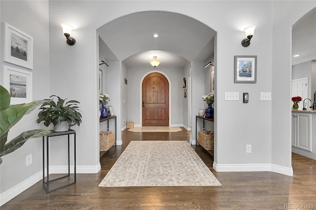 171 Columbine St, Larkspur, CO 80118 - foyer featuring arched walkways and wood finished floors