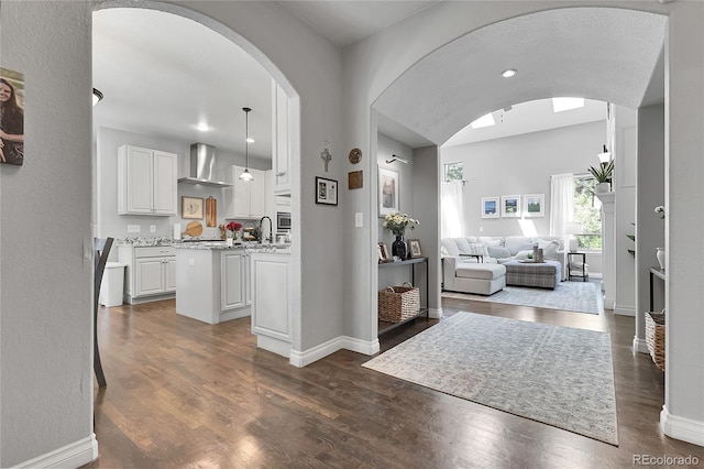 171 Columbine St, Larkspur, CO 80118 - entryway with arched walkways and dark wood-style flooring