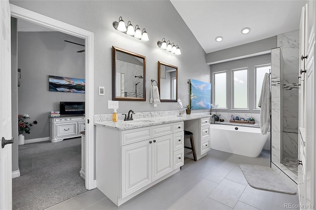 171 Columbine St, Larkspur, CO 80118 - bathroom featuring a soaking tub, vanity, lofted ceiling, a marble finish shower, and tile patterned flooring