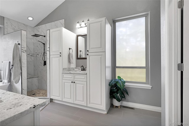171 Columbine St, Larkspur, CO 80118 - full bathroom featuring lofted ceiling, vanity, a marble finish shower, and tile patterned flooring