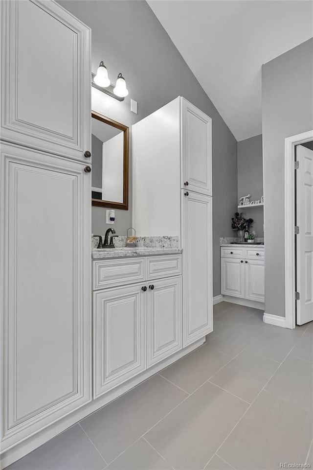171 Columbine St, Larkspur, CO 80118 - bathroom featuring tile patterned floors, vanity, and vaulted ceiling