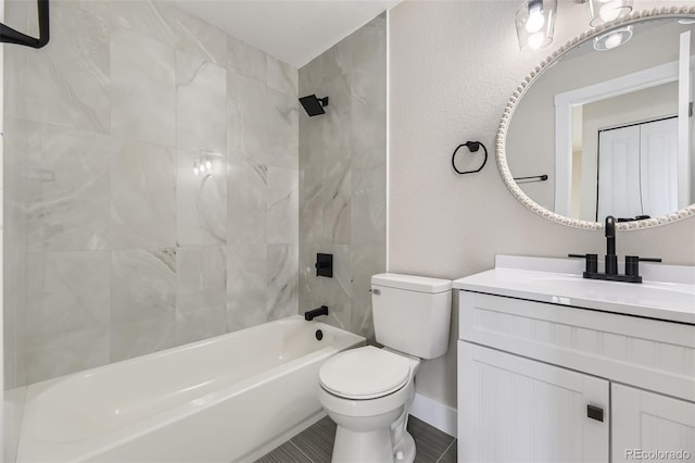 full bathroom with vanity, toilet, and tiled shower / bath combo