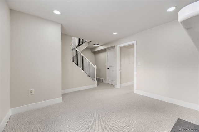 basement featuring light colored carpet