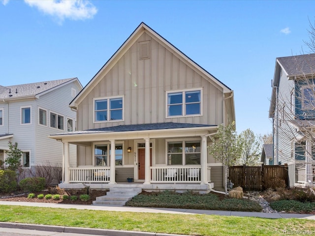 5511 Wabash St, Denver, CO 80238 - view of front of home featuring board and batten siding, a porch, and fence