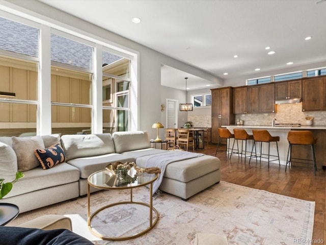 5511 Wabash St, Denver, CO 80238 - living area featuring dark wood-style flooring and recessed lighting