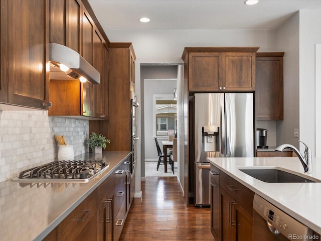 5511 Wabash St, Denver, CO 80238 - kitchen with a sink, stainless steel appliances, decorative backsplash, dark wood finished floors, and recessed lighting