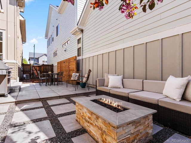 5511 Wabash St, Denver, CO 80238 - view of patio featuring an outdoor living space with a fire pit, central AC, fence, grilling area, and outdoor dining space