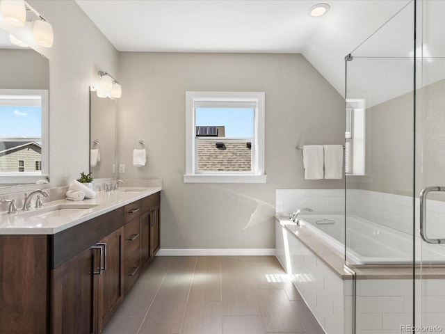5511 Wabash St, Denver, CO 80238 - full bath with plenty of natural light, a bath, double vanity, baseboards, and lofted ceiling