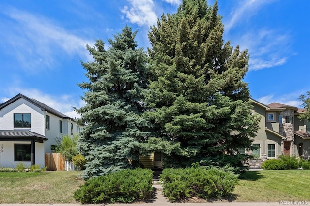 1665 S Madison St, Denver, CO 80210 - view of home's exterior with stucco siding, a standing seam roof, and a metal roof