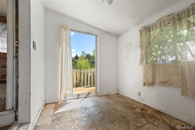 1665 S Madison St, Denver, CO 80210 - spare room featuring lofted ceiling