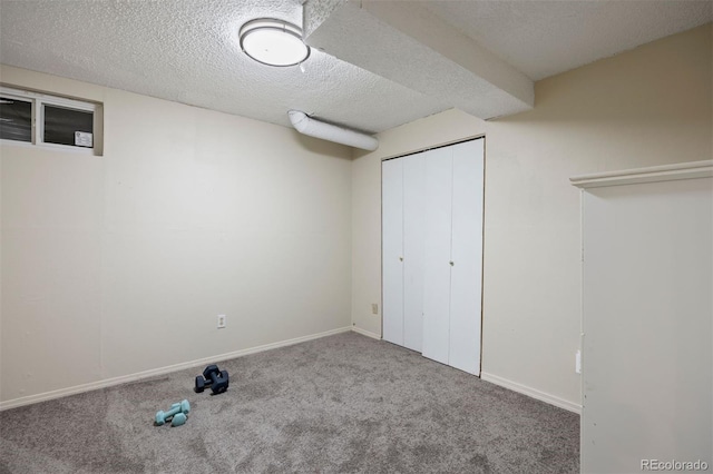 basement with a textured ceiling and carpet floors