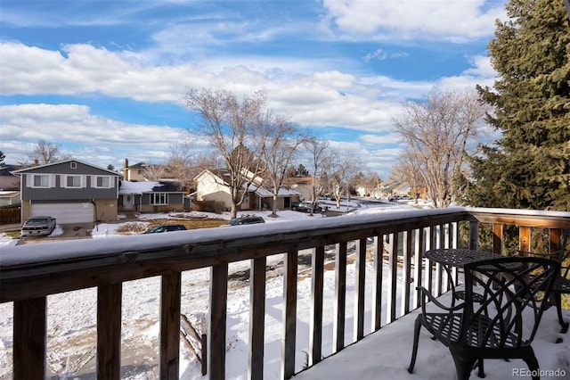 view of snow covered back of property