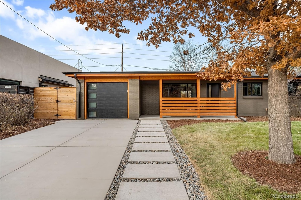 view of front of property featuring a garage and a front lawn