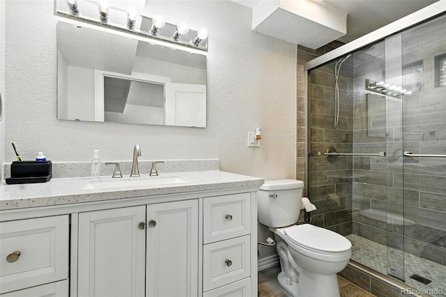 4604 Routt St, Wheat Ridge, CO 80033 - full bath featuring a textured wall, vanity, and a stall shower