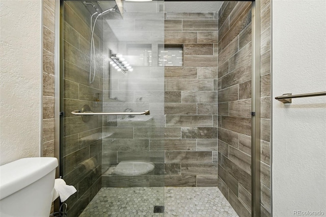 4604 Routt St, Wheat Ridge, CO 80033 - bathroom featuring a stall shower and a textured wall