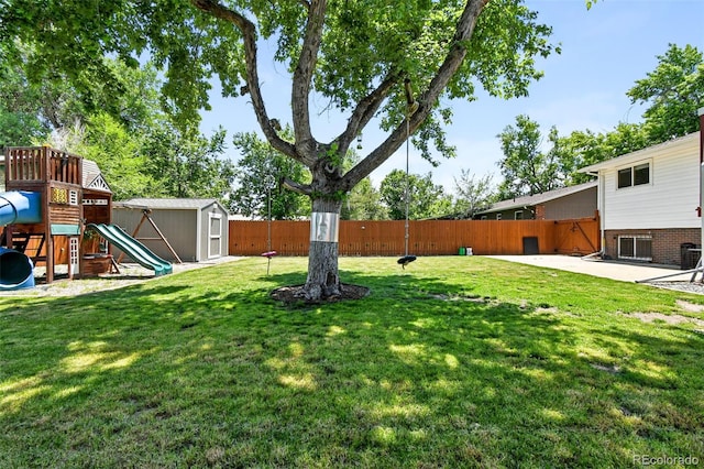 4604 Routt St, Wheat Ridge, CO 80033 - fenced backyard with a storage shed, a playground, and a patio