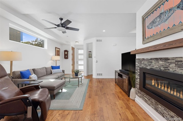 3932 Utica St, Denver, CO 80212 - living area featuring a tile fireplace, a healthy amount of sunlight, and visible vents