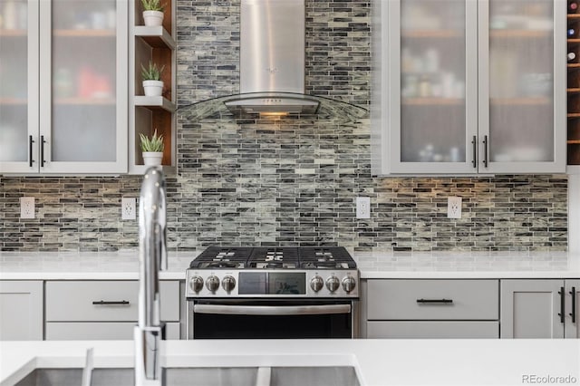3932 Utica St, Denver, CO 80212 - kitchen with gray cabinetry, light countertops, stainless steel gas range oven, and wall chimney range hood