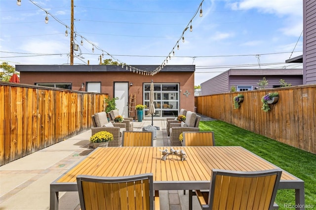 3932 Utica St, Denver, CO 80212 - rear view of house featuring a fenced backyard, a patio area, stucco siding, and an outdoor living space