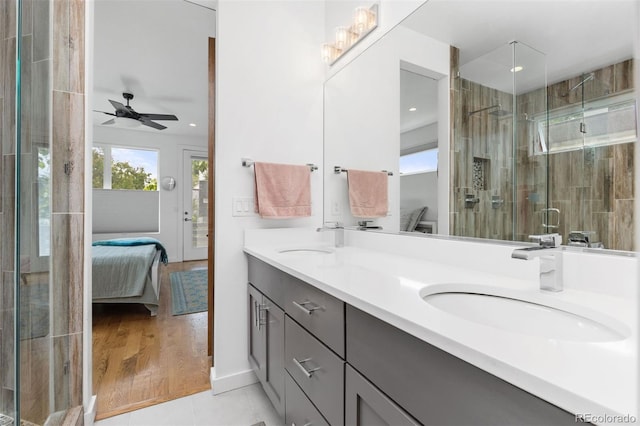 3932 Utica St, Denver, CO 80212 - full bath featuring double vanity, connected bathroom, a shower stall, and a sink