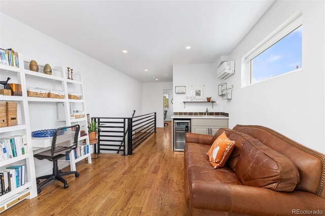 3932 Utica St, Denver, CO 80212 - living area with indoor wet bar, recessed lighting, light wood finished floors, a wall mounted AC, and beverage cooler