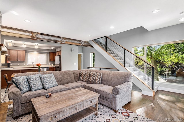 living room featuring beam ceiling and hardwood / wood-style flooring