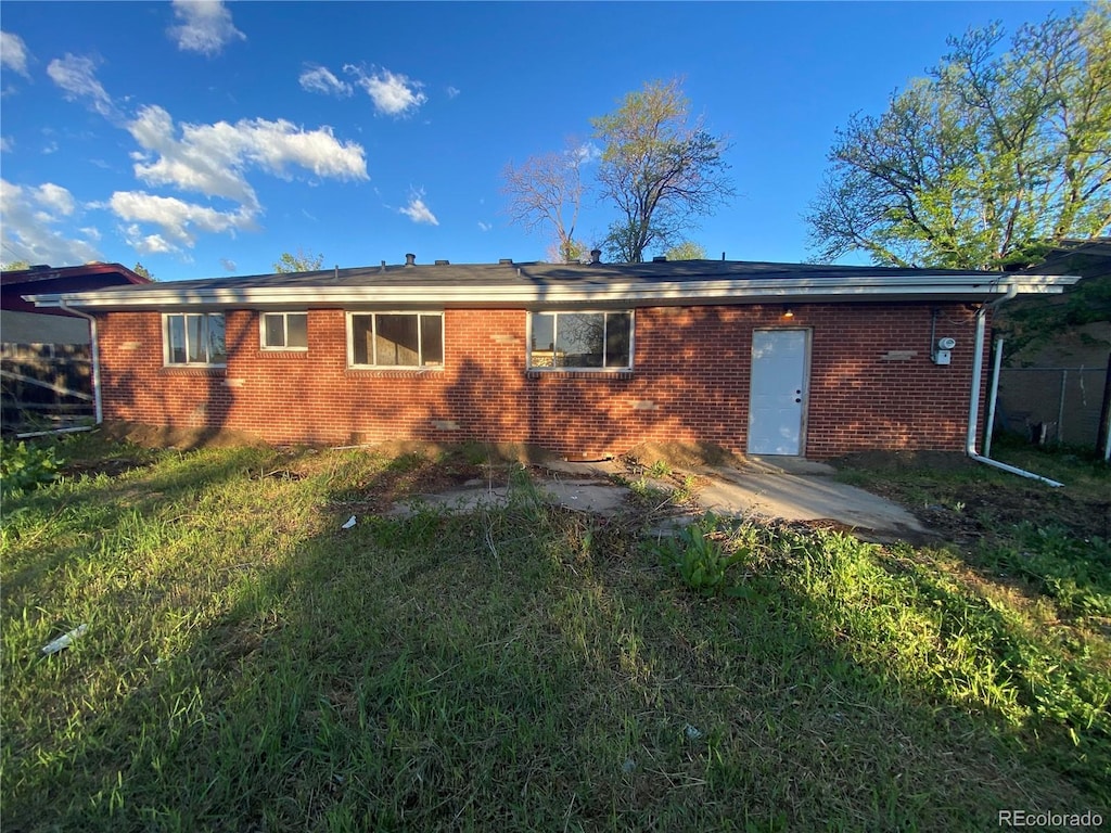back of house featuring brick siding
