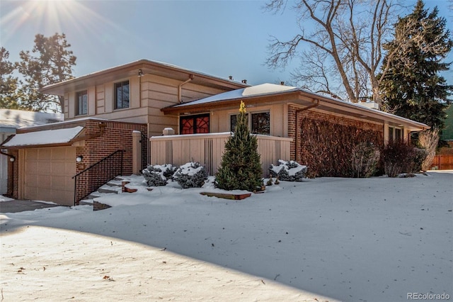 view of front of home featuring a garage and brick siding