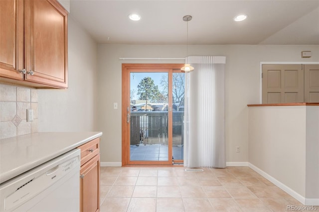 kitchen featuring white dishwasher, recessed lighting, light countertops, backsplash, and decorative light fixtures