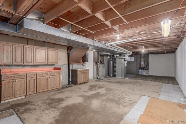 unfinished basement featuring gas water heater and heating unit