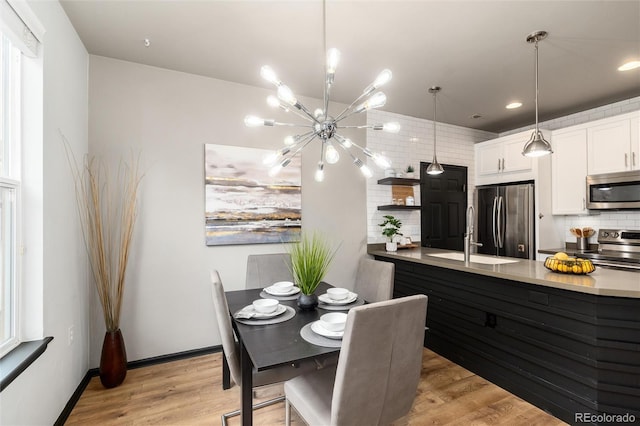kitchen featuring open shelves, white cabinetry, a chandelier, tasteful backsplash, and appliances with stainless steel finishes